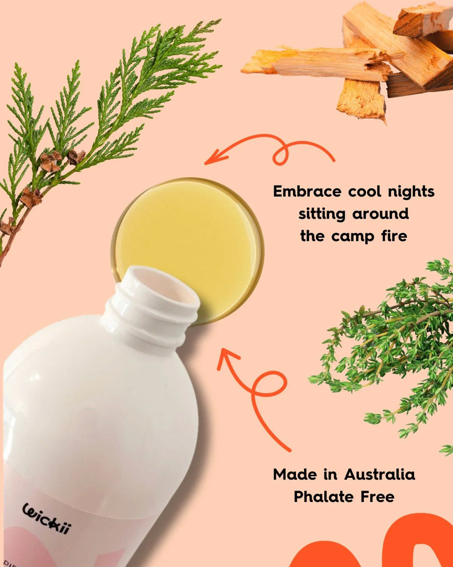 Candle fragrance oil bottle with cedar branches, wood chips, and yellow liquid, phthalate free