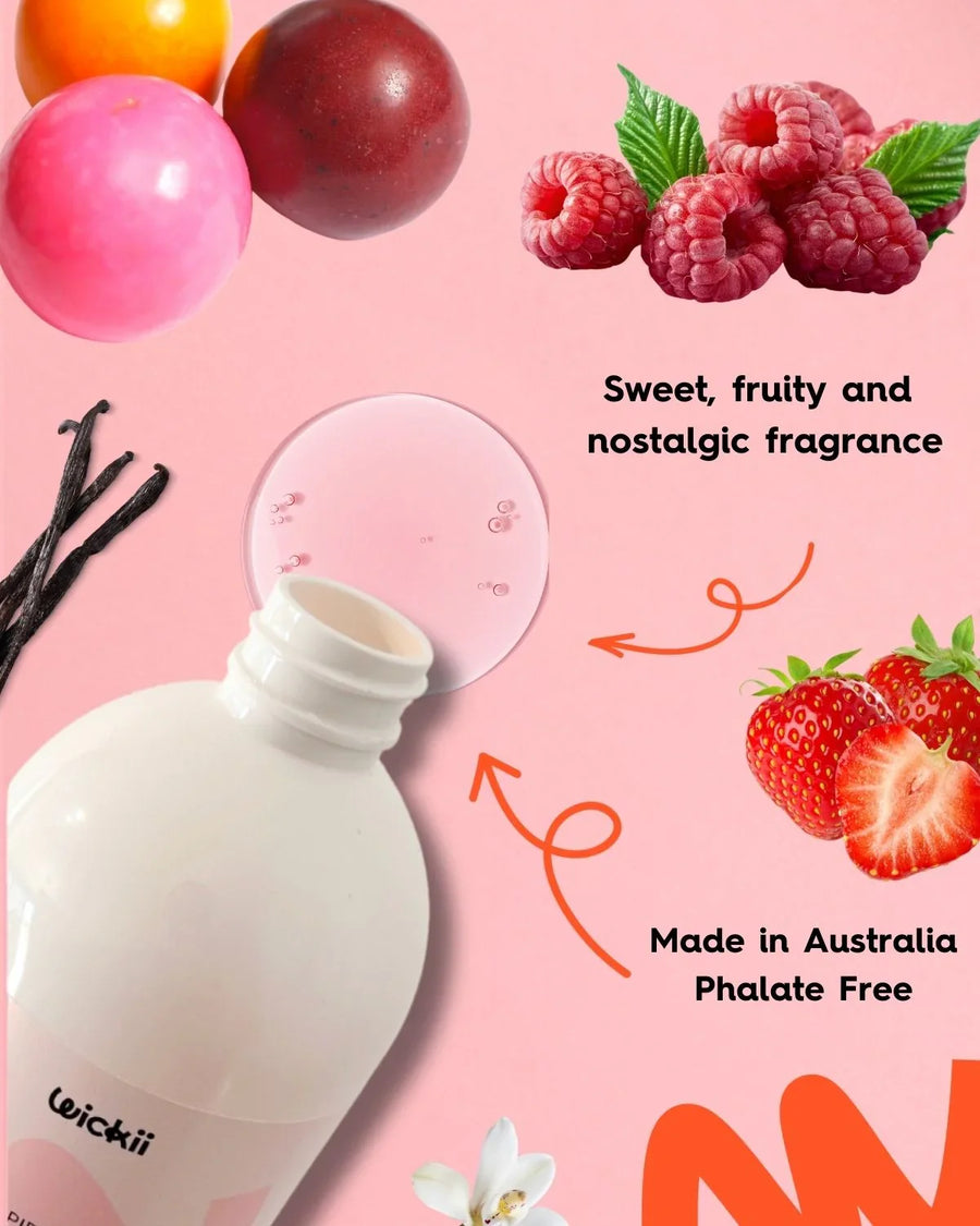 Fragrance oil bottle with vanilla, berries, and bubblegum imagery on a pink background