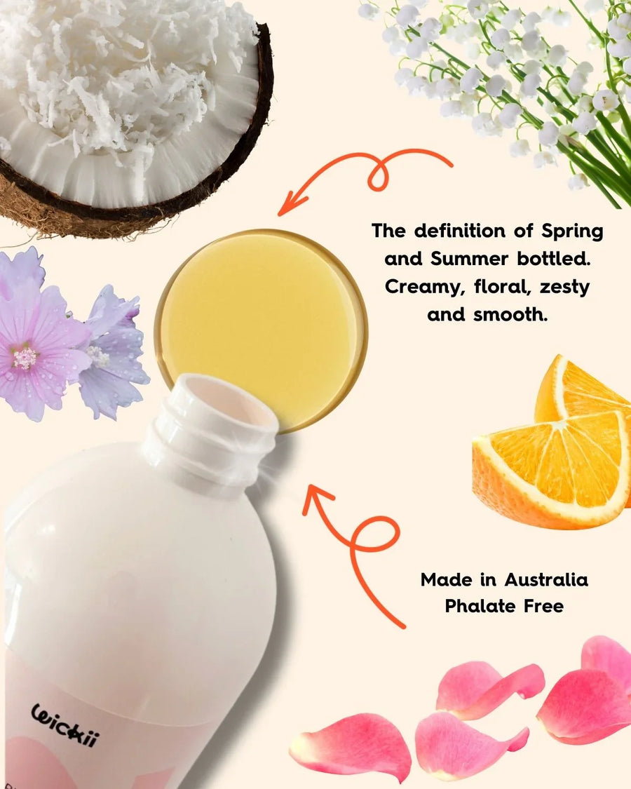 Fragrance oil bottle with coconut, orange slice, rose petals, lily of the valley, and floral scents.