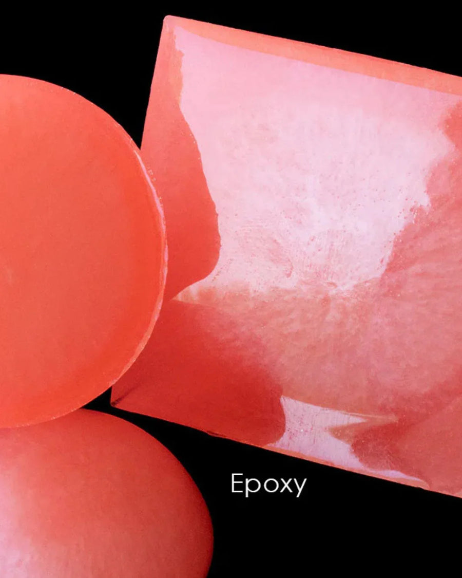 Translucent red epoxy resin soap base blocks on a black background