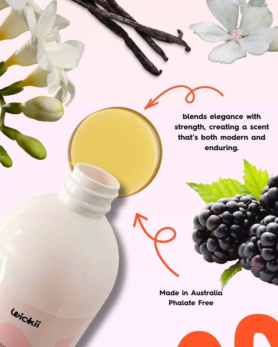 Candle fragrance oil bottle with vanilla, freesia flowers, blackberries, and green leaves