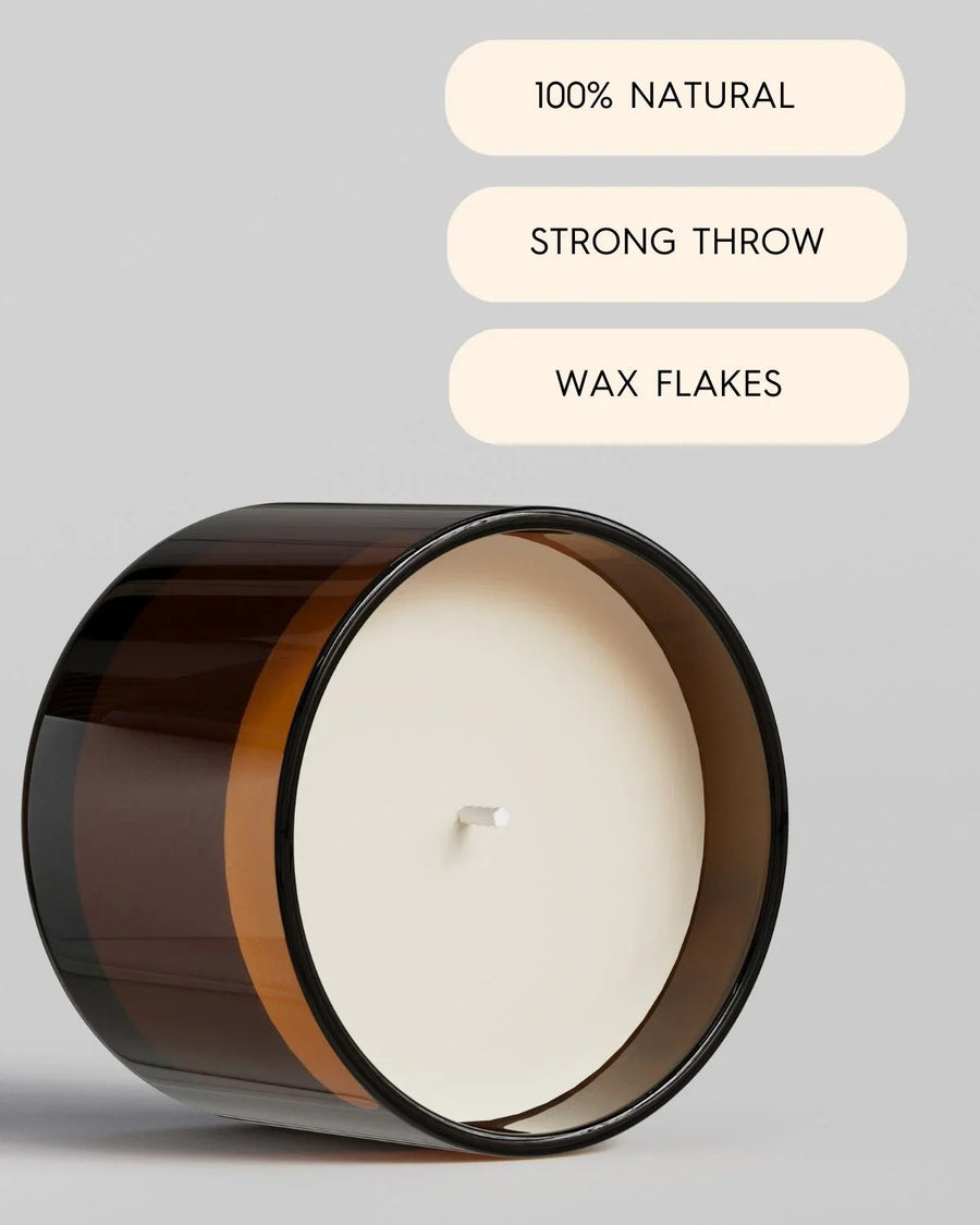 Brown glass candle jar with white wax, labeled 100% natural, strong throw, wax flakes