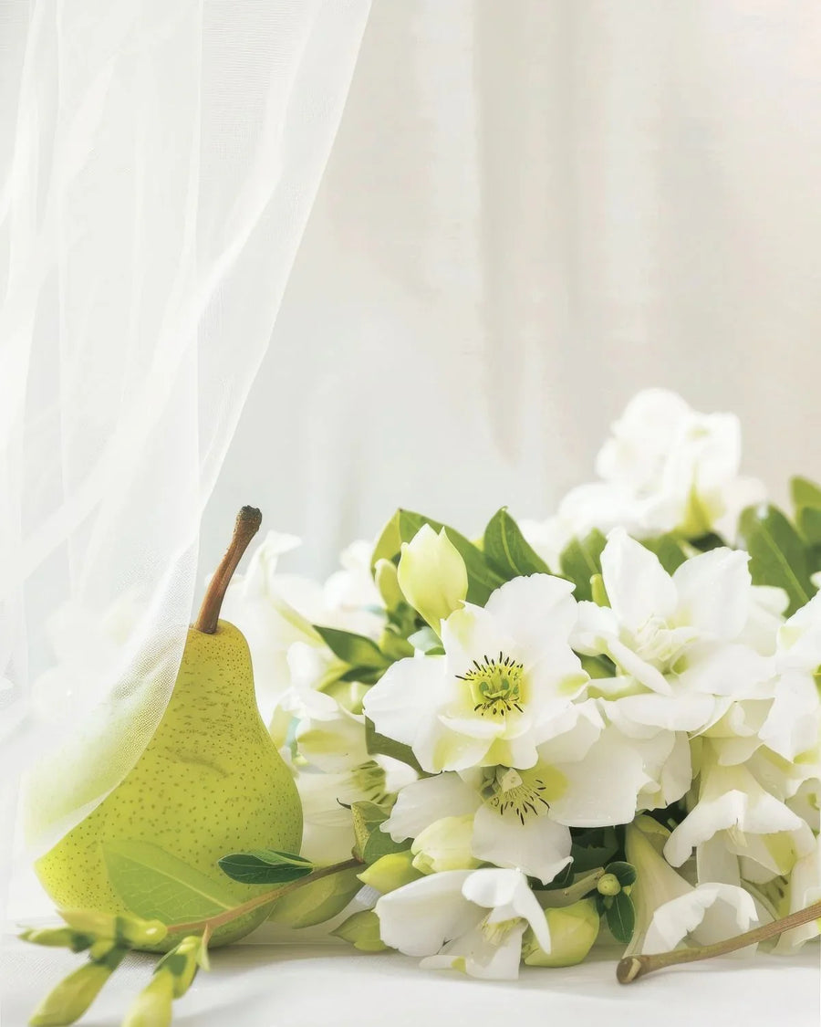 Fresh pear and white floral bouquet on soft white fabric, ideal for fragrance oils or candles
