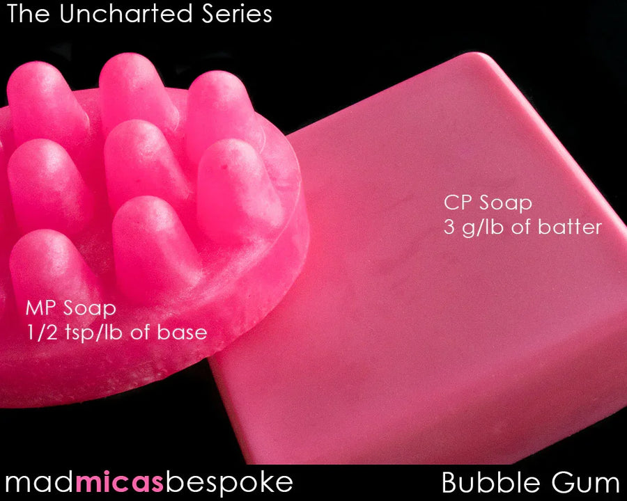 Bright pink bubble gum colored soap bars, one solid and one with bumps, on black background.