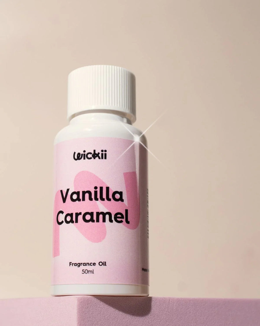 Vanilla Caramel fragrance oil bottle with white cap on pink block, 50ml size
