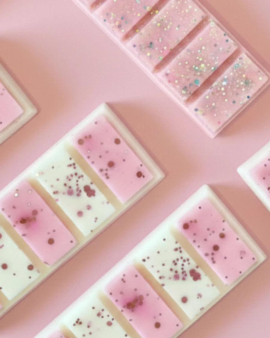 Pink snap wax melt bars with glitter on pastel background, candle making supplies