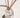 Clear glass reed diffuser with wooden sticks on a white surface, home fragrance decor