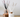 Modern reed diffusers with fragrance oil in minimalist glass bottles on a wooden surface