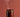 Brown glass jar candle with smoke rising, candle making supplies on warm background