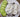 Handmade white soaps with black pepper, heart and round shapes, sliced cucumber on plate