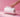 Hand pulling paper towel from stainless steel paper towel holder on pink background