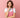 Woman in pink apron thinking, candle making supplies concept, pink background