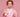 Woman in pink lab coat holding glass beakers, pink background, science-themed image