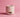 Pink ceramic candle warmer with rough textured surface on a matching pink background
