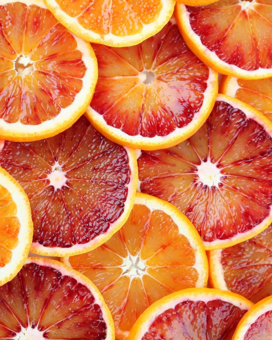Fresh blood orange slices with vibrant red and orange hues, citrus fruit close up