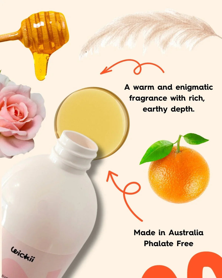 Fragrance oil bottle with honey, rose, orange, feather and text about earthy scent