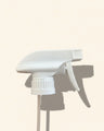 white 28/410 trigger spray nozzle for bottles on a neutral background