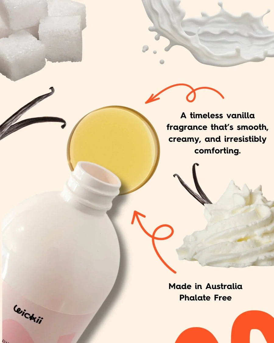 Vanilla fragrance oil bottle with vanilla pods, sugar cubes, fresh cream and milk splash.