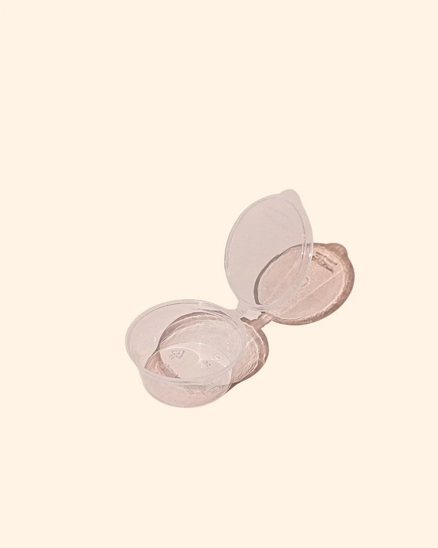 Clear 35mm flip top plastic cup container open on a plain light background