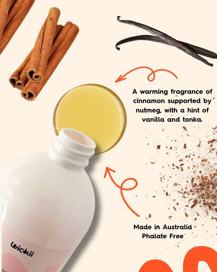 Candle fragrance oil bottle with cinnamon sticks, vanilla beans, and scent description.
