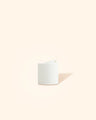 White plastic candle or diffuser bottle cap on a neutral background