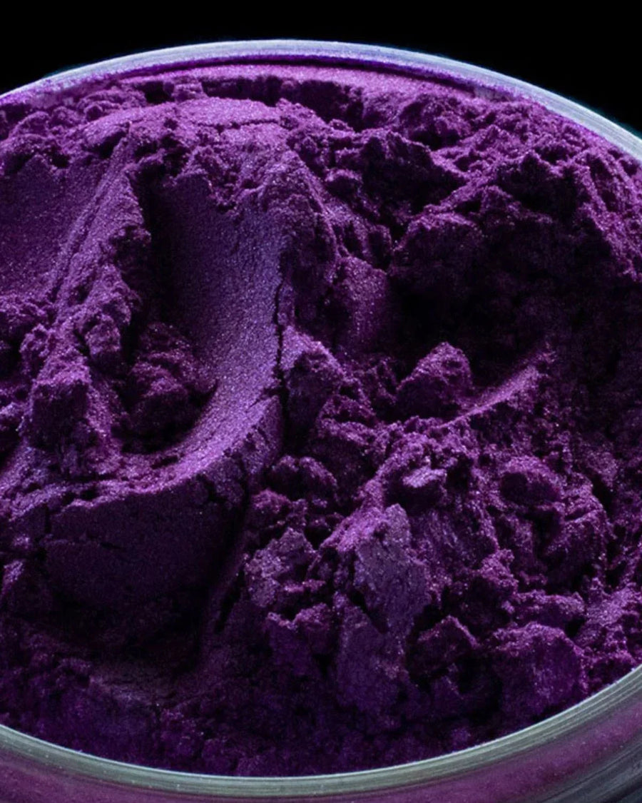 Bright purple mica powder for candle making, soap and craft supplies in a clear container