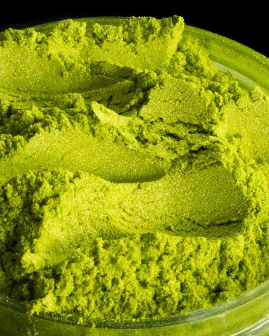 Bright green mica powder in a clear container for candle or soap making supplies
