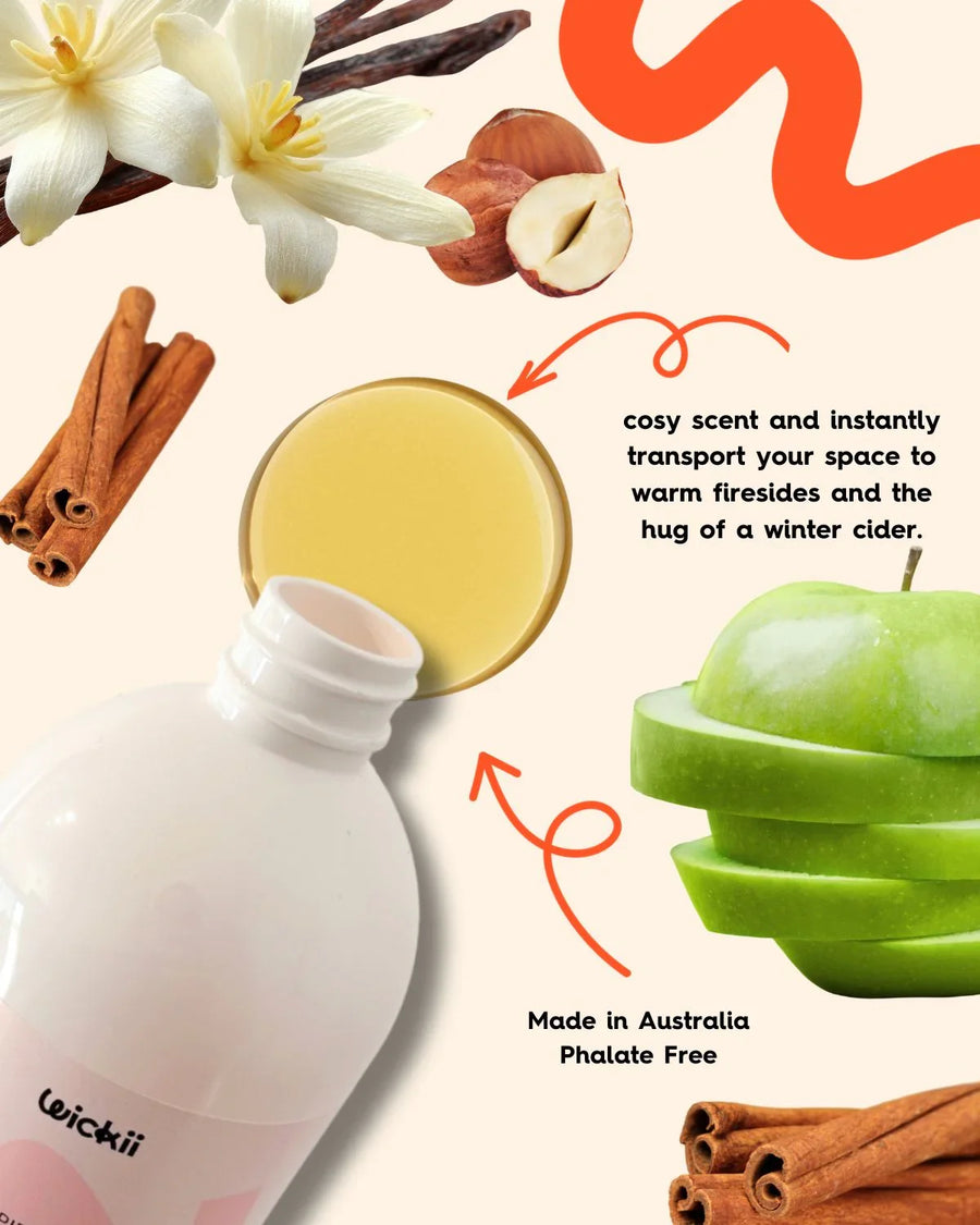 Fragrance oil bottle with apple, vanilla, hazelnut, cinnamon, and cozy scent text elements.