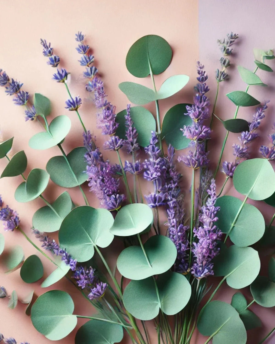 Lavender and eucalyptus stems with green leaves on pastel background, ideal for candle making inspiration.