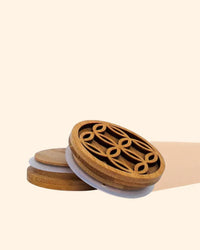 Round bamboo diffuser vent clips with geometric cutout design on a neutral background