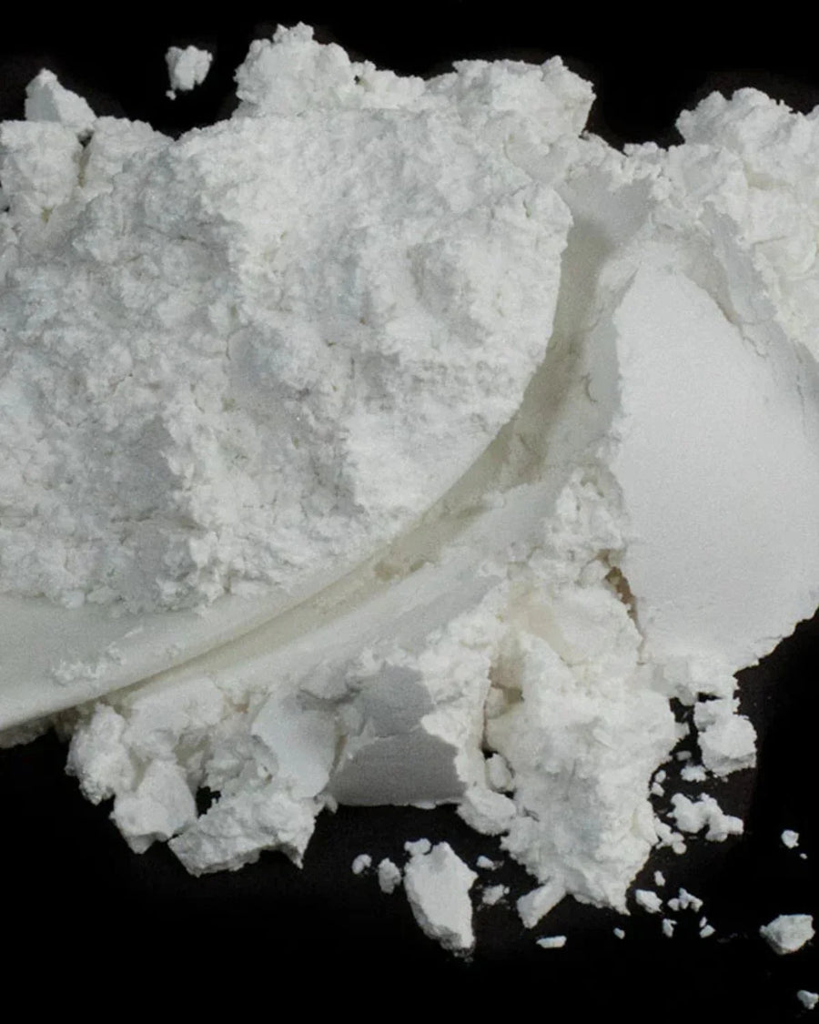 White soy wax flakes for candle making on a black background