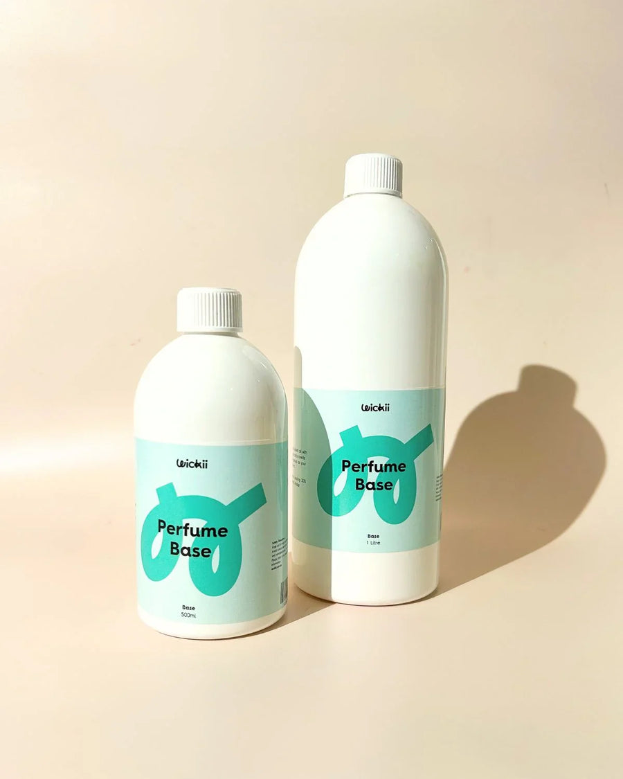 Two bottles of perfume base for candle or soap making on a neutral background.