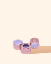 Rose gold candle jar lids with clear center, candle making supplies on beige background