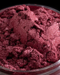Close-up of shimmering burgundy mica powder for candle or soap making supplies