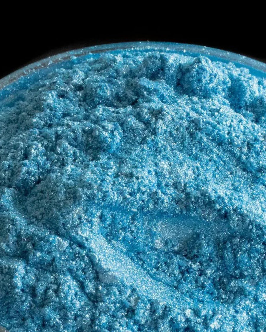 Bright blue mica powder pigment for candle making and soap crafting in a clear container