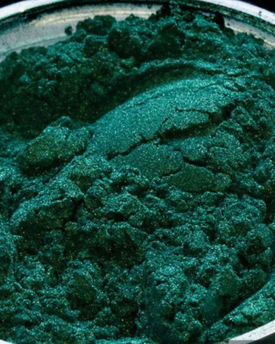 Shimmery green mica powder for candle or soap making in a metal container