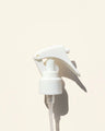 White mini trigger spray nozzle for bottles on a light background, ideal for diffusers.