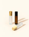 roller ball frosted bottle with gold or bamboo lid and amber bottle with black bottle